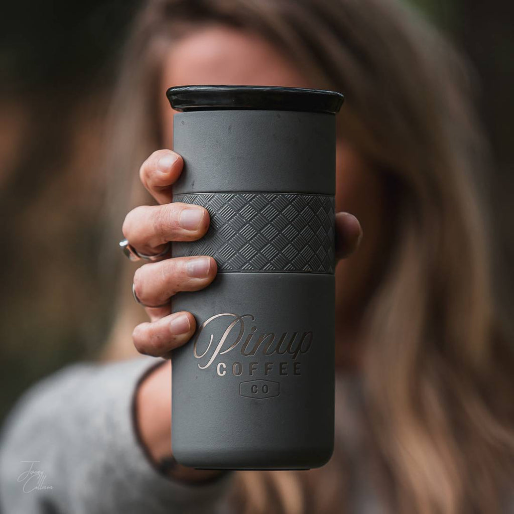 Woman holding grey 16 ounce coffee stainless tumbler