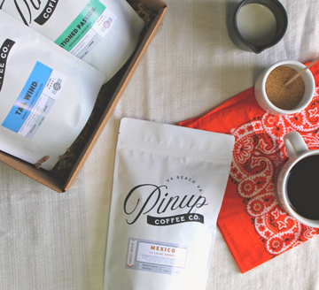 Coffee subscription, fresh roasted coffee bags and a cup of coffee with cream and sugar